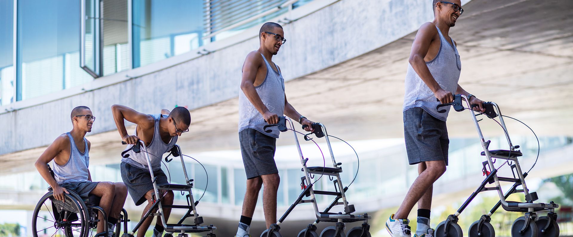 David Mzee standing up from his wheelchair and using his rollator